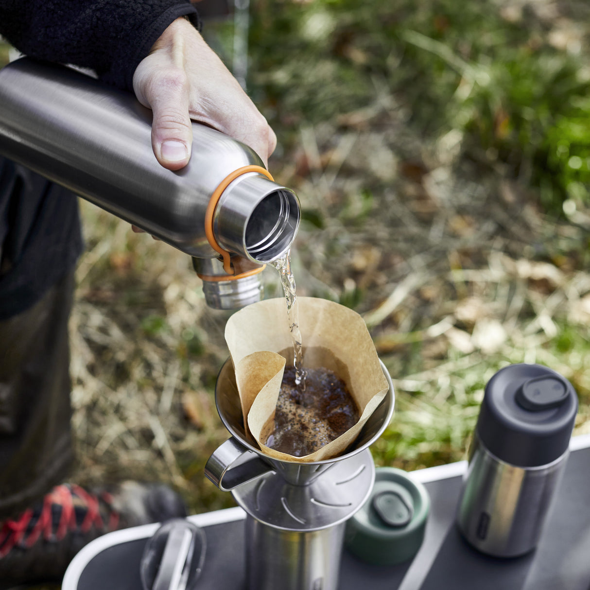 BLACK+BLUM Isolierflasche, Edelstahl, zum Wasser- und Kaffeetrinken, zeigt Wasser, das in die Flasche gegossen wird