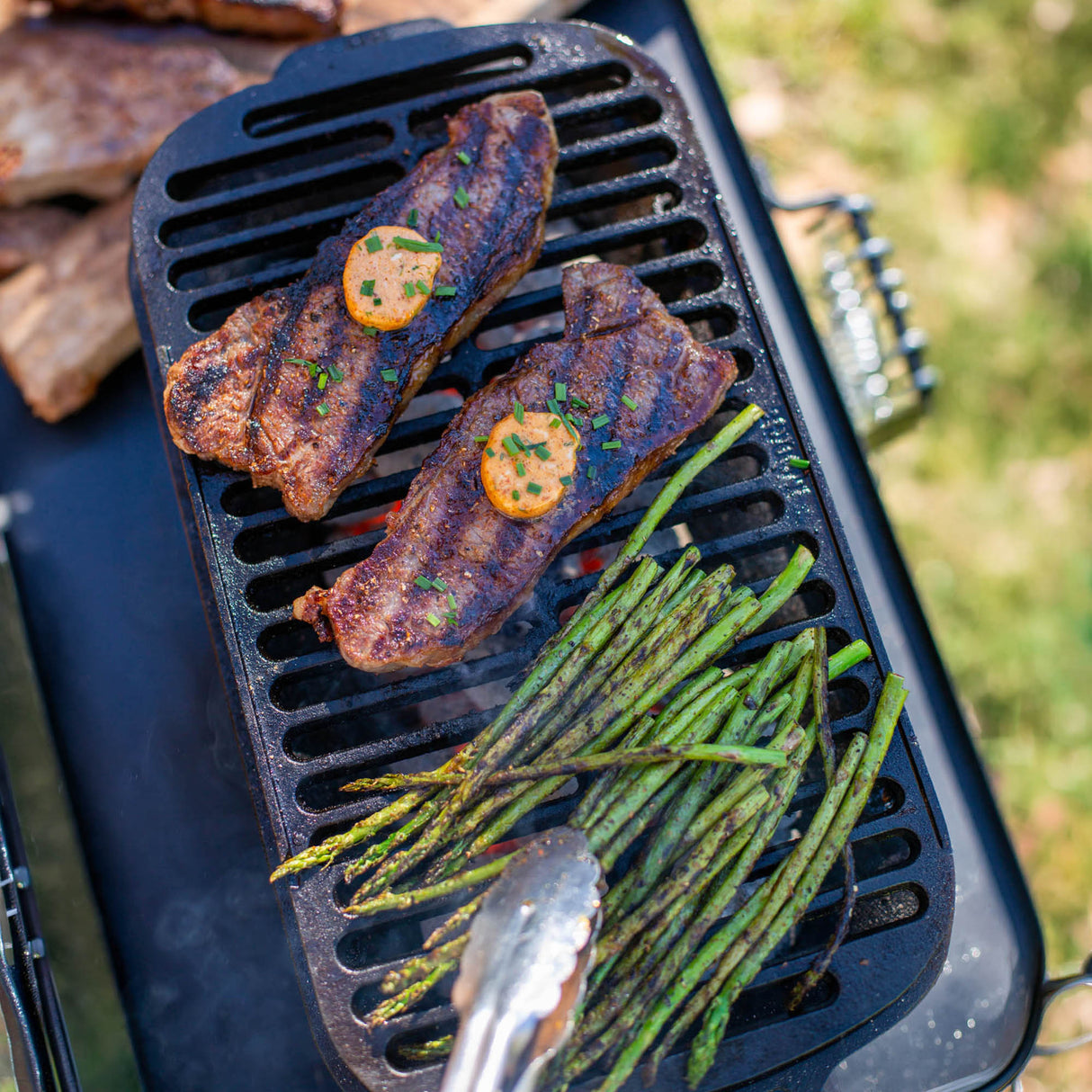 Schwarzer Lodge Grill aus Gusseisen mit Deckel und Griffen, ideal für Grillabende und Kochzwecke.